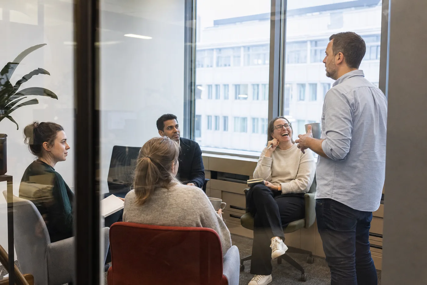 A manager leading a short team follow-up discussion after compliance training